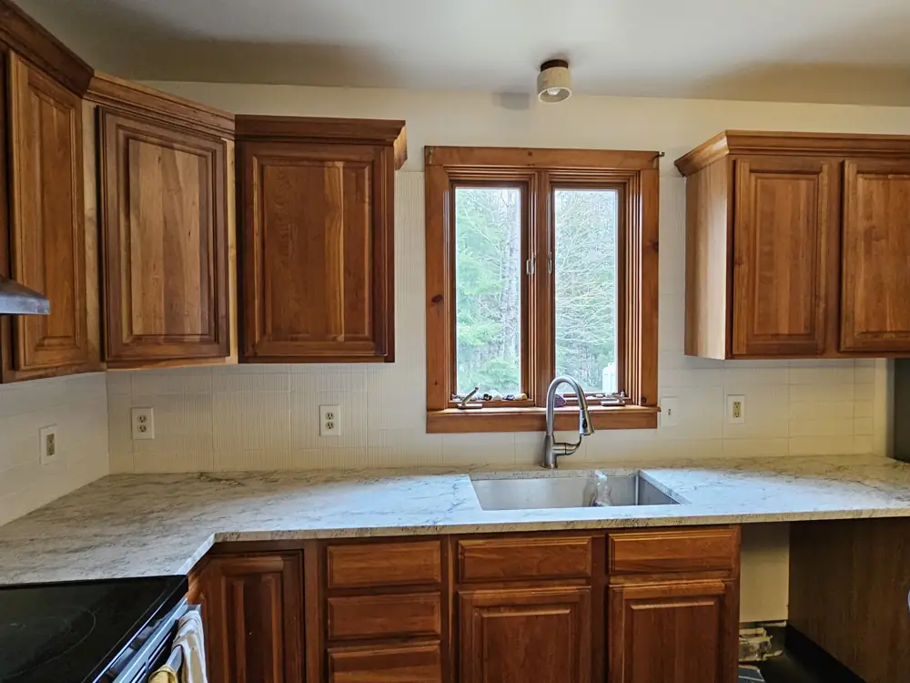 Kitchen with new granite counters, undermount sink and fluted tile backsplash