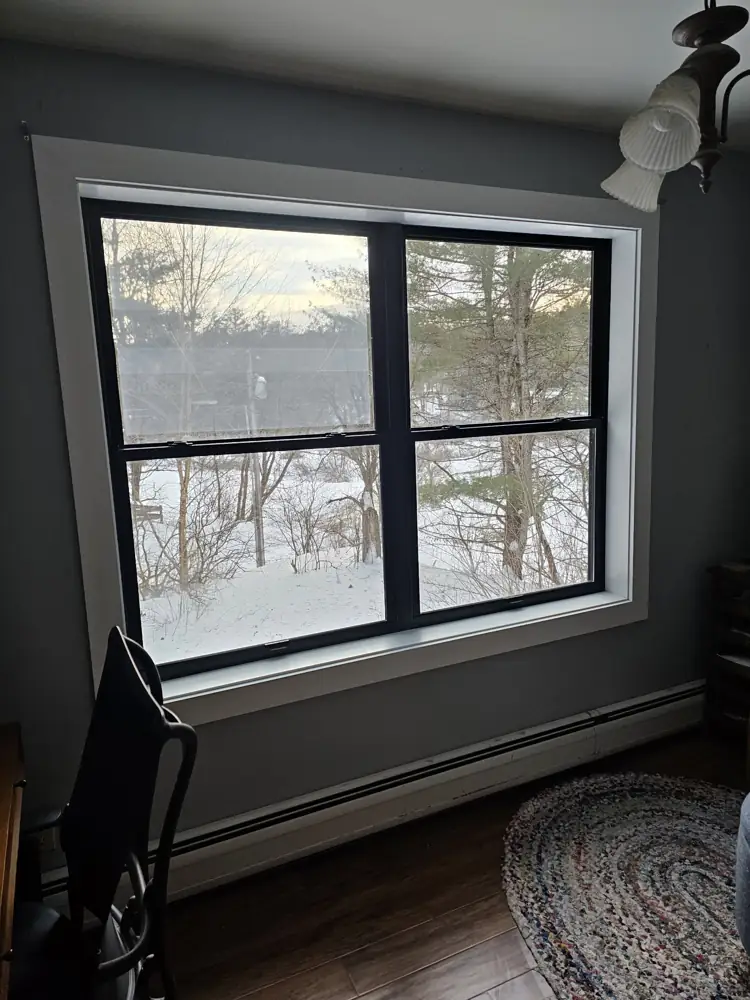 New black double window with white casing and deep sill