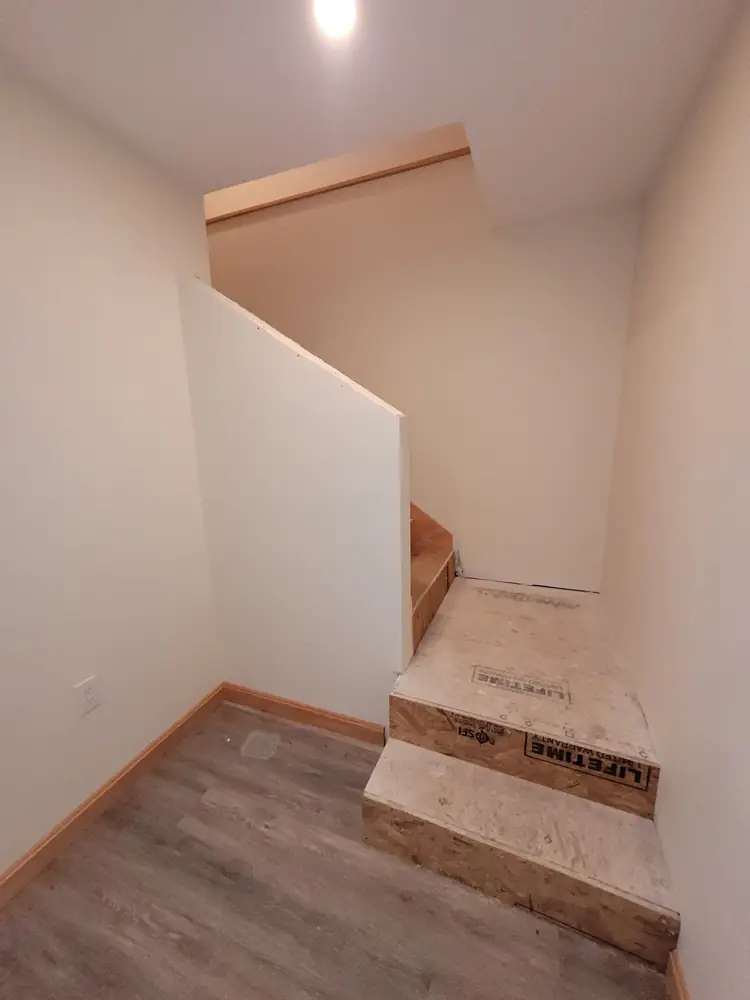 Stairs and landing sheathed in subfloor with a new half wall