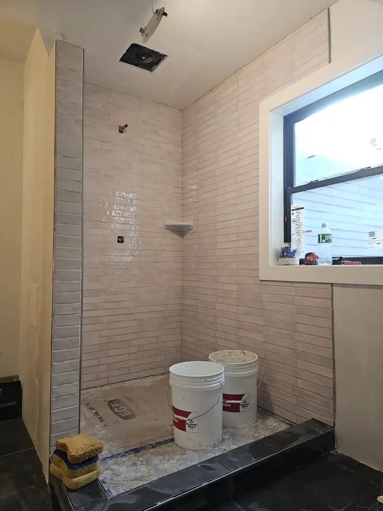 Shower walls fully tiled before fixtures